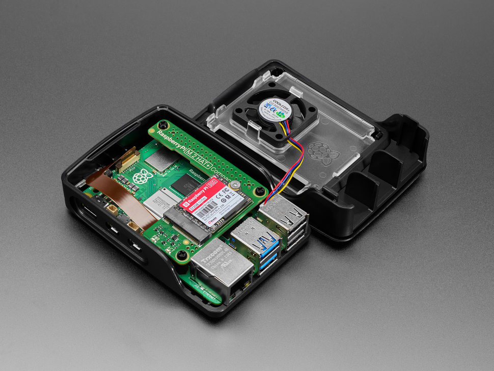 Angled Demo Shot of Raspberry Pi Case + Fan opened up showing the Raspberry Pi 5 equipped with the Raspberry Pi M.2 HAT+ Compact with SSD.