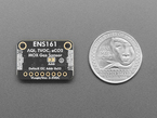 Back of black, rectangle-shaped MOX gas sensor breakout with U.S. quarter for scale.