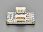 Close-up of tan 4-pin JST-SH connector on PCB.