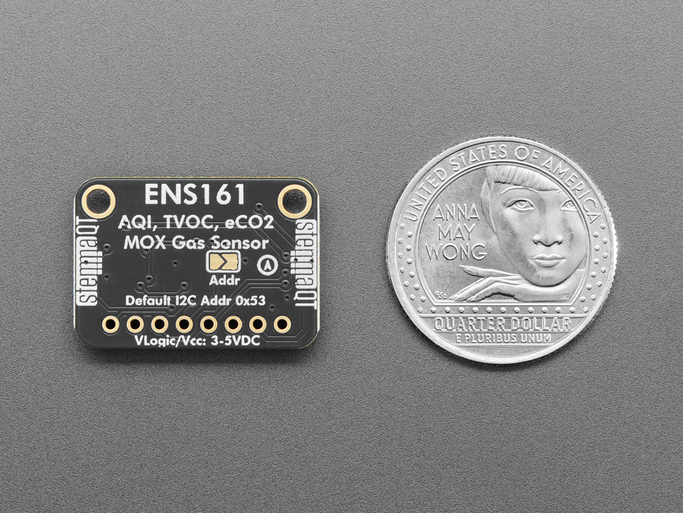 Back of black, rectangle-shaped MOX gas sensor breakout with U.S. quarter for scale.