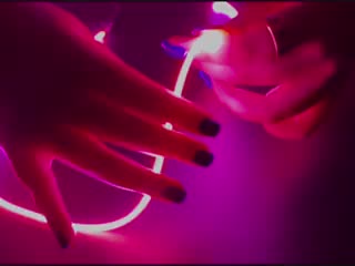 Video of hands playing with a pink LED filament.