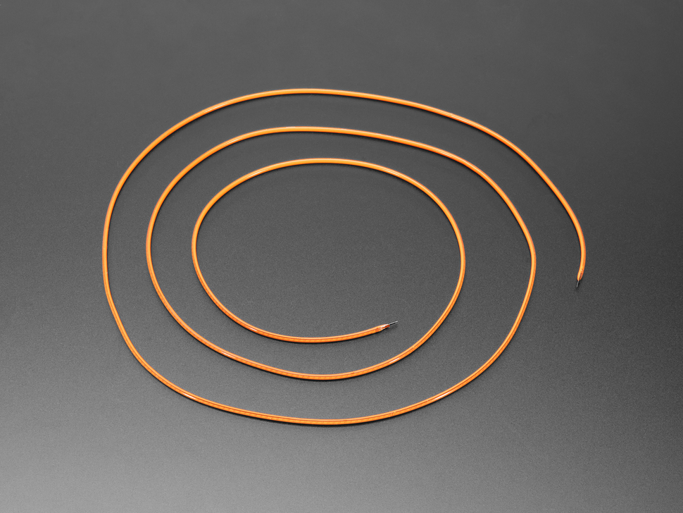 Angled shot of long, orange LED filament coiled.