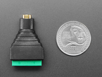 audio jack 4-pin terminal block with U.S. quarter for scale.