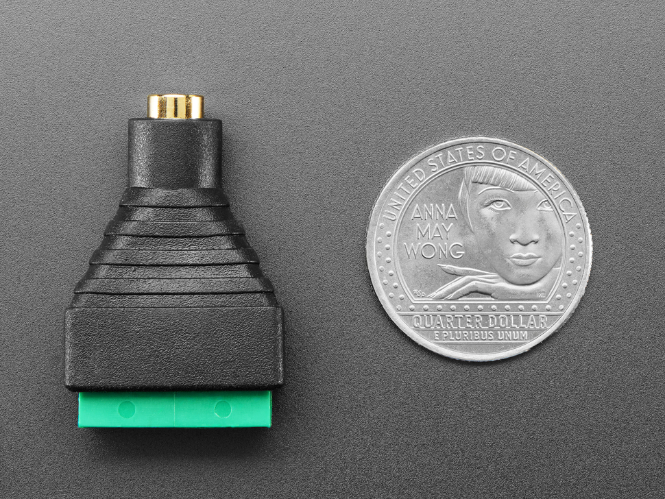audio jack 4-pin terminal block with U.S. quarter for scale.