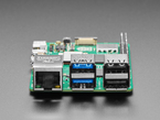 Close-up of Ethernet and USB-A jacks on green microcontroller.
