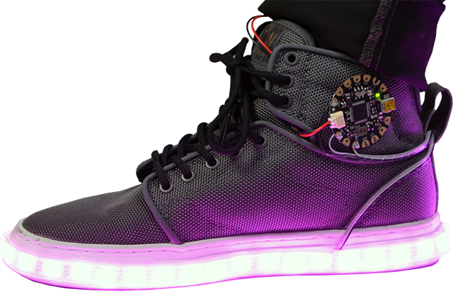Side view of a shoe with an Adafruit FLORA board attached and LED light strip around the bottom glowing purple