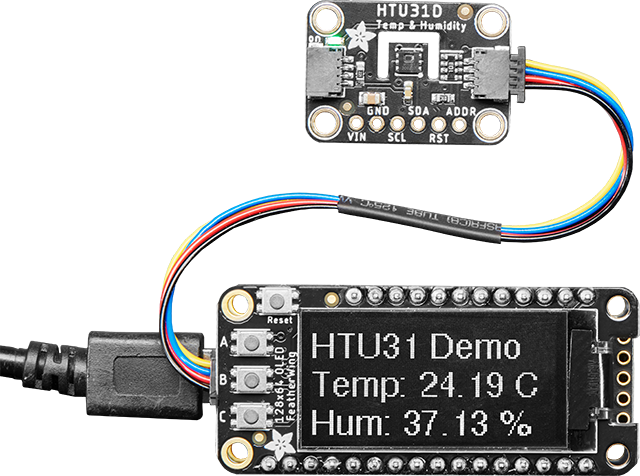 HTU31D Temperature and Humidity board connected to an OLED FeatherWing  with STEMMA cable showing the temperature and humidity readings.